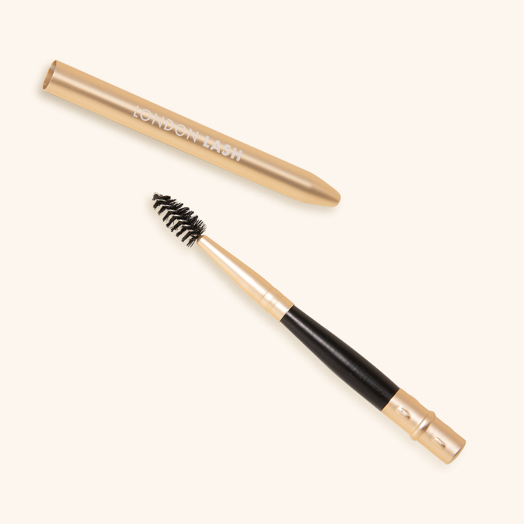 On the Go Lash Wand - reusable eyelash spoolie with a sleek gold handle for precise eyelash application.
